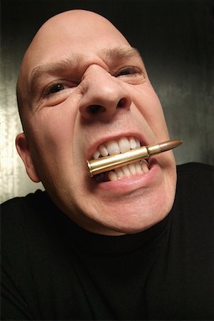 Man With Bullet in his Mouth Stock Photo - Rights-Managed, Code: 700-00269098