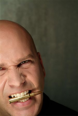Man With Bullet in his Mouth Stock Photo - Rights-Managed, Code: 700-00269099