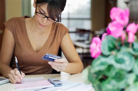 simsearch:700-00814372,k - Woman Writing on Bill Holding Credit Card Stock Photo - Rights-Managed, Code: 700-00269277