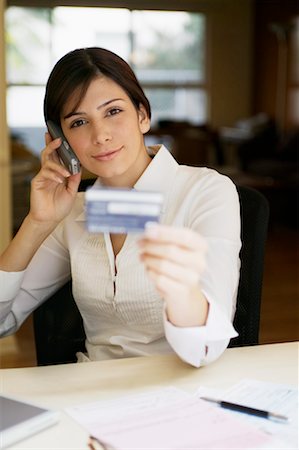 Woman on Phone Holding Credit Card Stock Photo - Rights-Managed, Code: 700-00269270