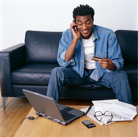 Man Holding Credit Card, Using Laptop and Cell Phone Stock Photo - Rights-Managed, Code: 700-00269456