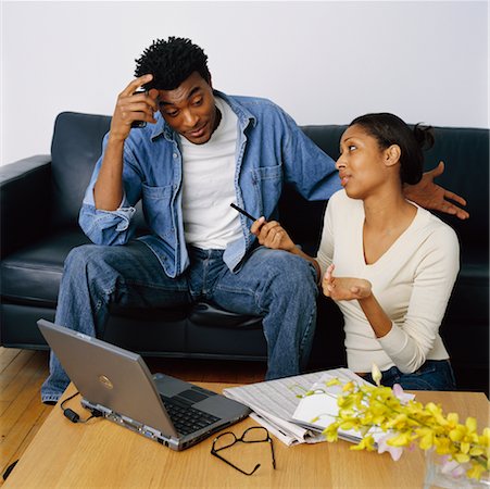 simsearch:700-01015565,k - Couple Sitting on Sofa Discussing Their Personal Finances Stock Photo - Rights-Managed, Code: 700-00269451