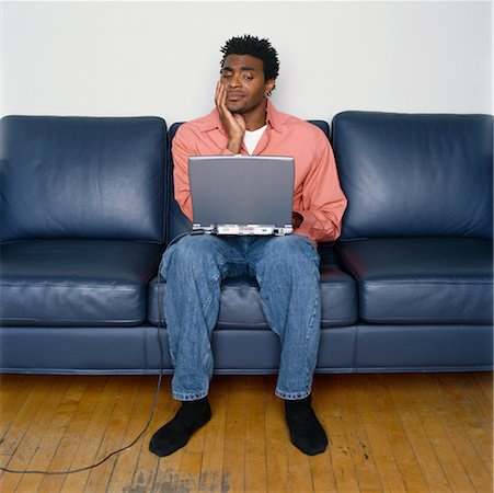 picture of man confused with cable - Man Sitting on Sofa Using Laptop Stock Photo - Rights-Managed, Code: 700-00269468