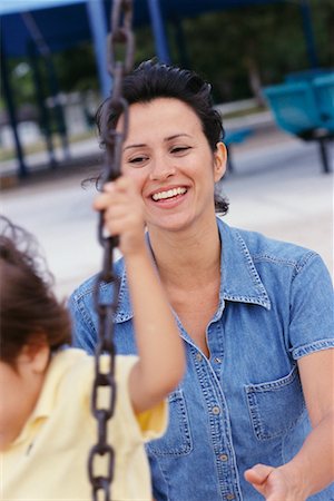 Mother Pushing Child on Swing Fotografie stock - Rights-Managed, Codice: 700-00269574