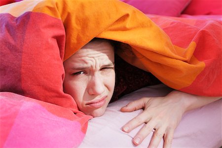 Woman Hiding Under Covers in Bed Stock Photo - Rights-Managed, Code: 700-00270352