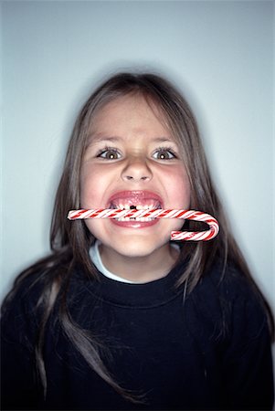Girl Biting Candy Cane Stock Photo - Rights-Managed, Code: 700-00285472