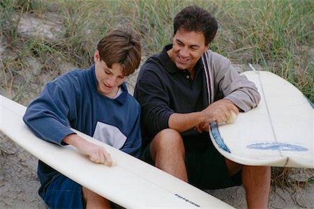 Father and Son Waxing Surfboards Stock Photo - Rights-Managed, Code: 700-00285918