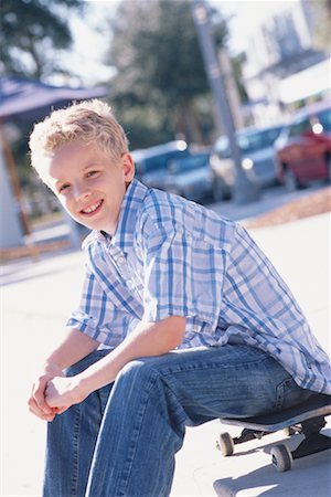 portrait of boy sitting on skateboard - Portrait of Boy Stock Photo - Rights-Managed, Code: 700-00286138