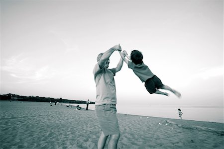 dad swinging kids at beach - Father Playing with Son on Beach Stock Photo - Rights-Managed, Code: 700-00280091