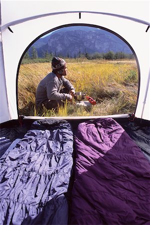 Man Cooking Outside Tent Stock Photo - Rights-Managed, Code: 700-00280783