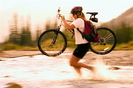 female cycling glasses - Woman Crossing River with Mountain Bike Stock Photo - Rights-Managed, Code: 700-00281792