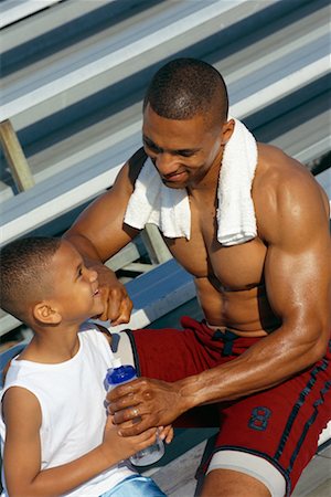 elementary age boy belly - Athlete Father with Son Stock Photo - Rights-Managed, Code: 700-00318356