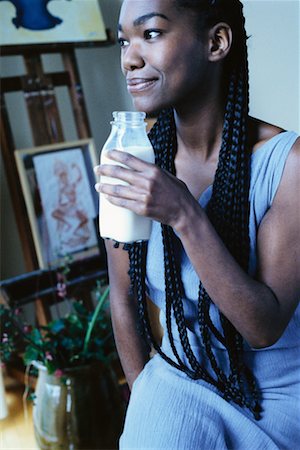 satisfied (thirst) - Woman Holding Bottle of Milk Foto de stock - Con derechos protegidos, Código: 700-00328279