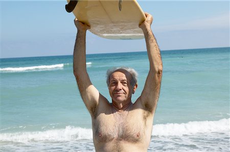 simsearch:700-00547097,k - Homme tenant la planche de Surf Photographie de stock - Rights-Managed, Code: 700-00328541
