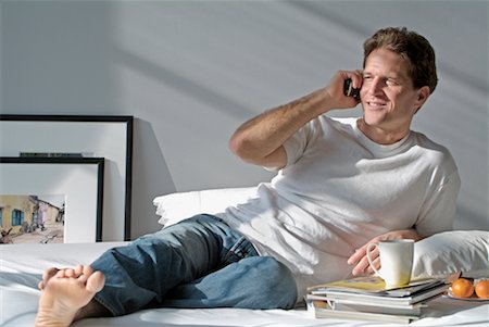 simsearch:700-00782647,k - Man Using Cell Phone on Bed Stock Photo - Rights-Managed, Code: 700-00328688