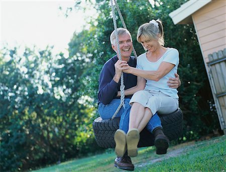 senior couple playing yard - Couple on Tire Swing Stock Photo - Rights-Managed, Code: 700-00345237
