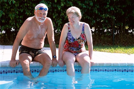 Couple Sitting at Pool Side Stock Photo - Rights-Managed, Code: 700-00345612