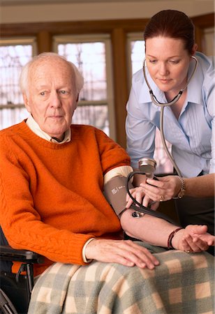 Woman Taking Man's Blood Pressure Stock Photo - Rights-Managed, Code: 700-00341069