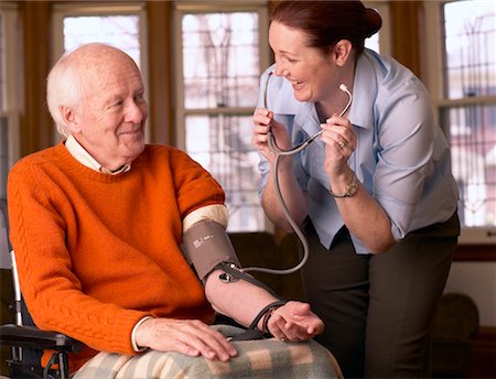 Woman Taking Man's Blood Pressure Stock Photo - Rights-Managed, Code: 700-00341076