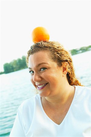 fat people balance - Woman with Orange on Head Stock Photo - Rights-Managed, Code: 700-00342242