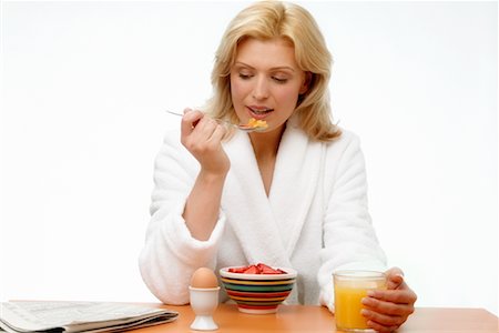 Woman Eating Breakfast Foto de stock - Con derechos protegidos, Código: 700-00342396