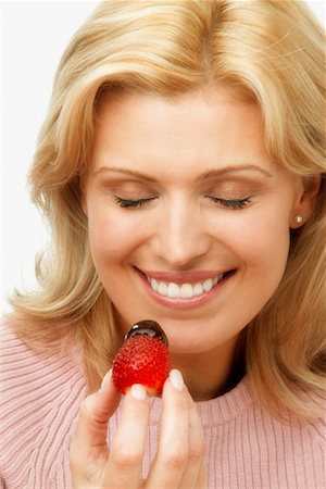 Woman Eating Chocolate Dipped Strawberry Stock Photo - Rights-Managed, Code: 700-00342410