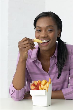 french fry smile - Woman Eating French Fries Stock Photo - Rights-Managed, Code: 700-00342873