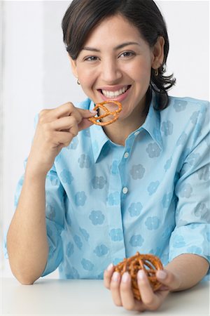 photo of people eating pretzels - Woman Eating Pretzels Stock Photo - Rights-Managed, Code: 700-00342888