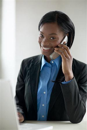 Businesswoman with Cell Phone And Laptop Stock Photo - Rights-Managed, Code: 700-00342883