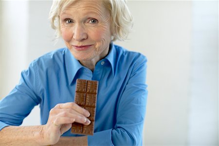 Woman Eating Chocolate Bar Stock Photo - Rights-Managed, Code: 700-00342936