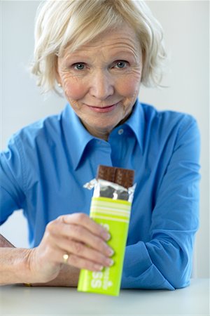 Woman Eating Chocolate Bar Stock Photo - Rights-Managed, Code: 700-00342937