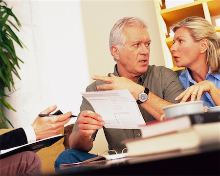 financial advisor talking to couple - Couple Discussing Finances Foto de stock - Con derechos protegidos, Código: 700-00343334