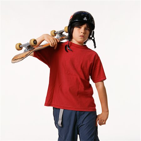 pictures of skateboards for 11 year old boys - Boy with Skateboard in Studio Stock Photo - Rights-Managed, Code: 700-00357137