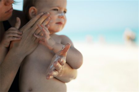 Mother Applying Sunscreen to Baby Stock Photo - Rights-Managed, Code: 700-00357369