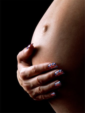 Woman's Hand on Pregnant Stomach Stock Photo - Rights-Managed, Code: 700-00357534