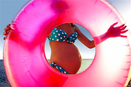 pink inner tube - Pregnant Woman with Inflatable Ring Stock Photo - Rights-Managed, Code: 700-00357533