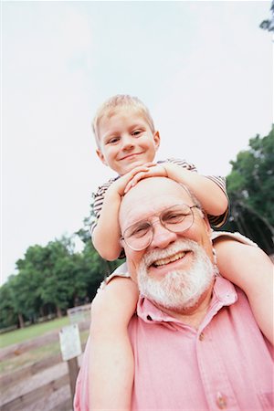 fat bald man with glasses - Boy on Grandfather's Shoulders Stock Photo - Rights-Managed, Code: 700-00357782