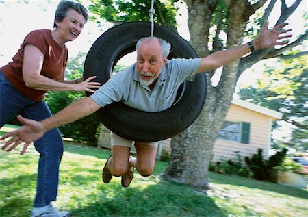 ridiculous husband senior couple - Couple on Tire Swing Stock Photo - Rights-Managed, Code: 700-00350175