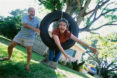 ridiculous husband senior couple - Couple on Tire Swing Stock Photo - Rights-Managed, Code: 700-00350176