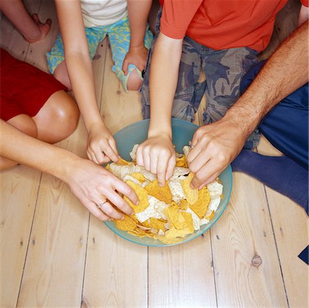 Family Eating Chips Stock Photo - Rights-Managed, Code: 700-00364172