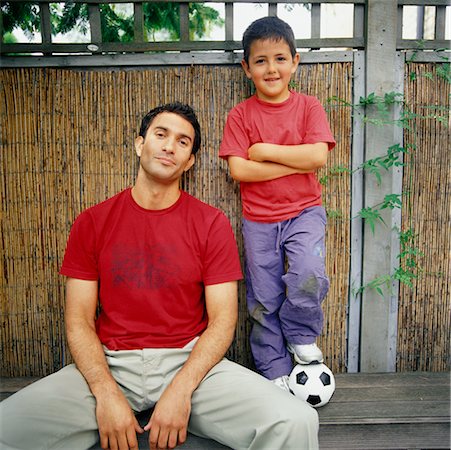 father son sitting on a bench - Man and Boy with Soccer Ball Stock Photo - Rights-Managed, Code: 700-00364234