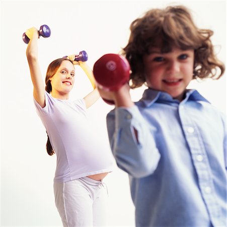elementary age boy belly - Pregnant Mother and Son Lifting Weights Stock Photo - Rights-Managed, Code: 700-00367634
