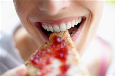 Close Up of Woman Eating Bread Stock Photo - Rights-Managed, Code: 700-00363358