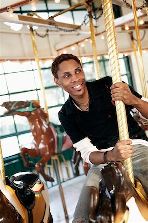 simsearch:700-00371712,k - Man Riding Merry-Go-Round Stock Photo - Rights-Managed, Code: 700-00371716