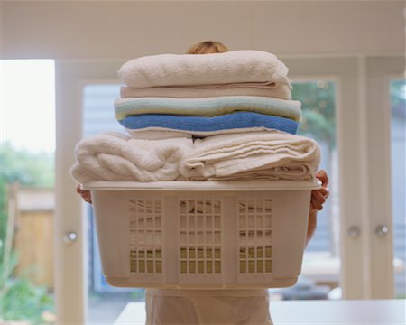 smelling laundry - Woman Holding Laundry Basket Stock Photo - Rights-Managed, Code: 700-00424086