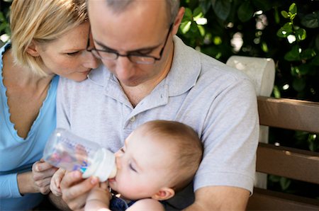 father son sitting on a bench - Parents Feeding Baby Stock Photo - Rights-Managed, Code: 700-00424551