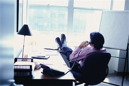 sitting back feet up desk - Businessman on Phone with Feet Up Stock Photo - Rights-Managed, Code: 700-00424991