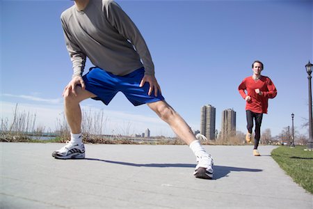 simsearch:700-00425475,k - Man Stretching in Front of Other Man Jogging Stock Photo - Rights-Managed, Code: 700-00425475