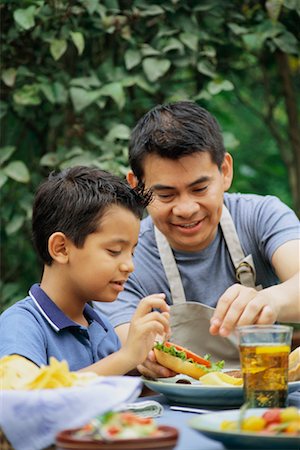 family eating burgers - Father and Son at Barbeque Stock Photo - Rights-Managed, Code: 700-00425959