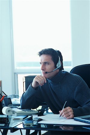 Man in Office with Headset and Paperwork Stock Photo - Rights-Managed, Code: 700-00426215